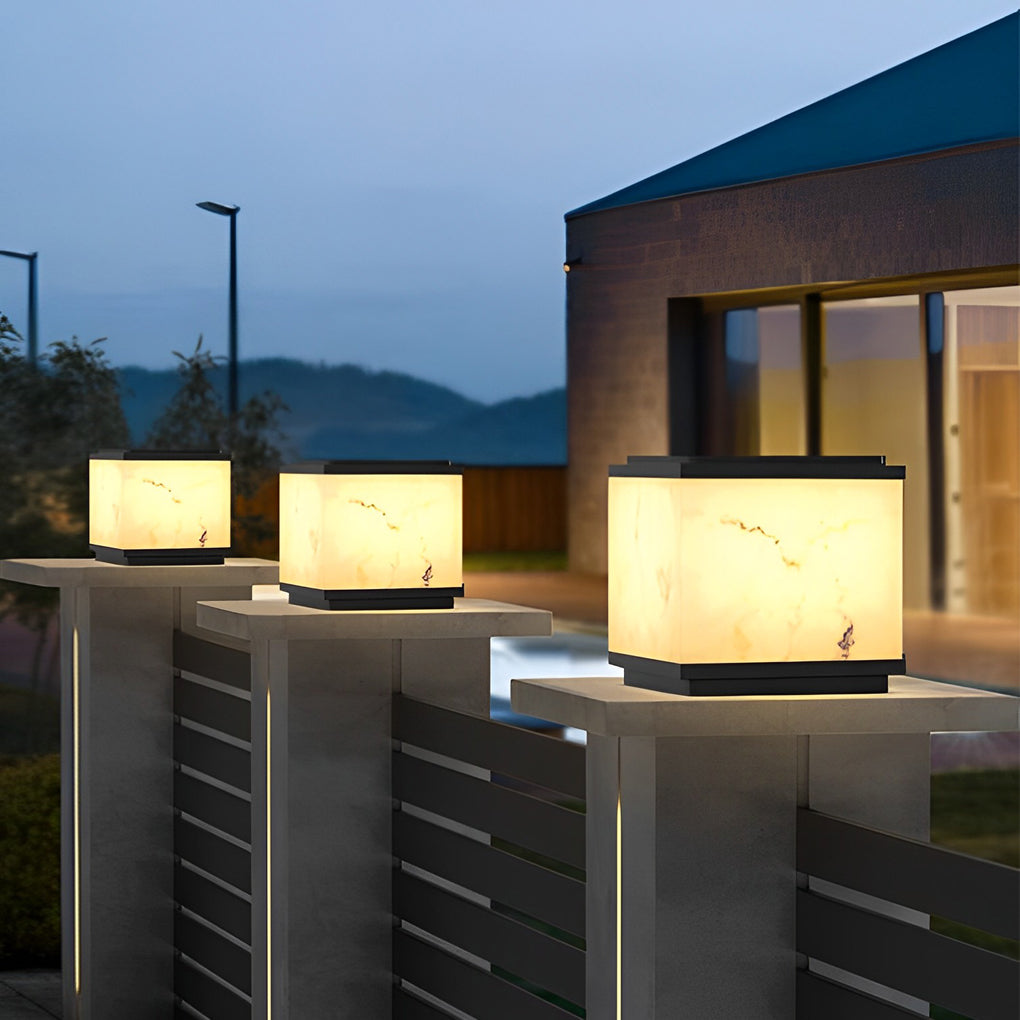 Outdoor stone pillar lights mounted on a balcony railing, providing ambient lighting with a scenic view.