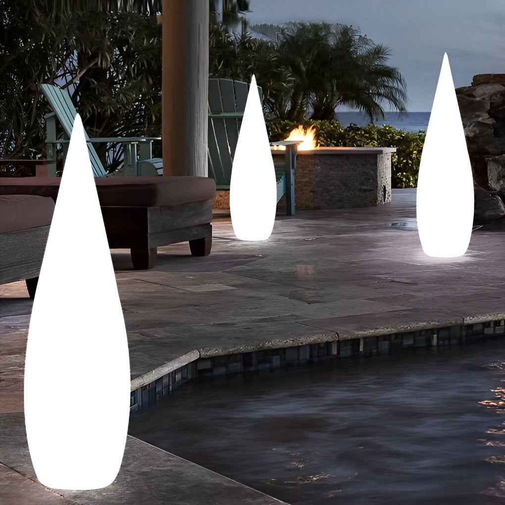 Outdoor teardrop floor light with smooth matte finish in modern exterior setting.