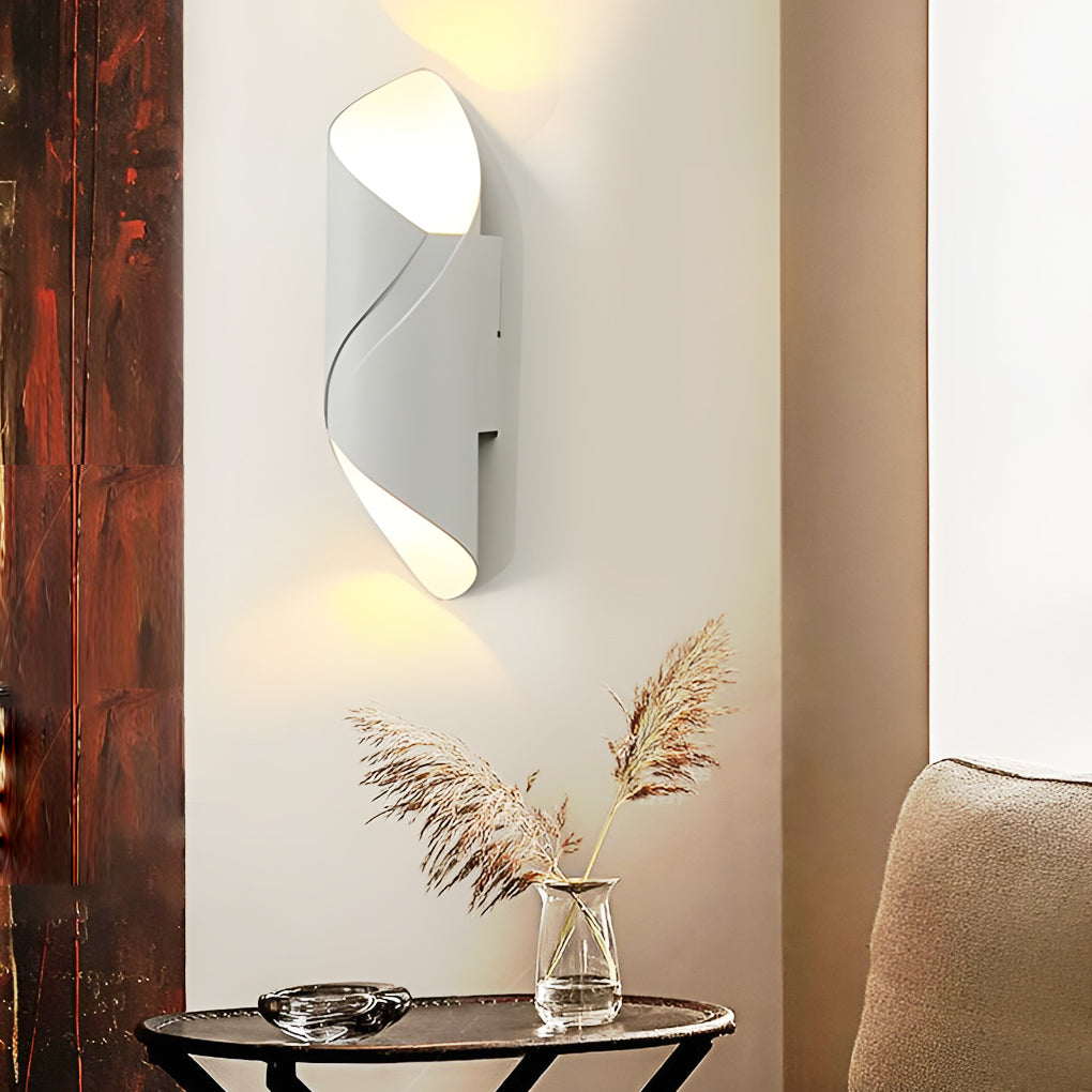 Outdoor up down wall light with white and gold design, mounted beside dark curtains.