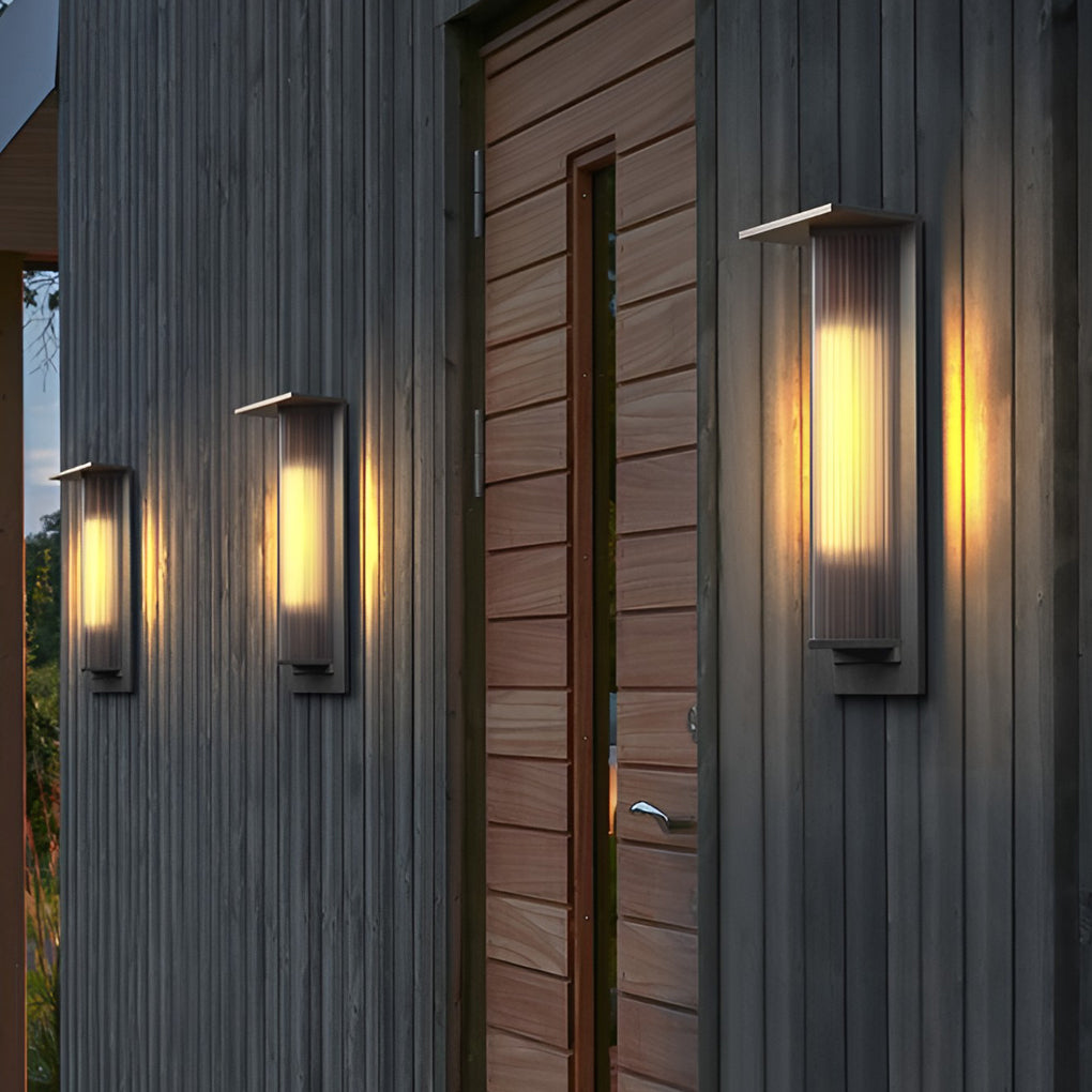 Outdoor vertical wall sconce illuminating a cozy outdoor deck with directional glow.