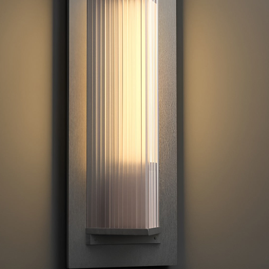 Outdoor vertical wall sconce with detailed view of its ribbed glass and structure.