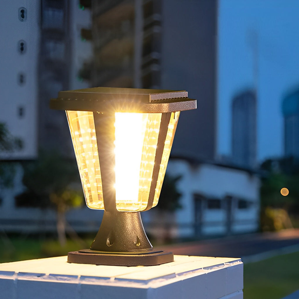 Outdoor waterproof post lamp casting a gentle glow near green foliage.