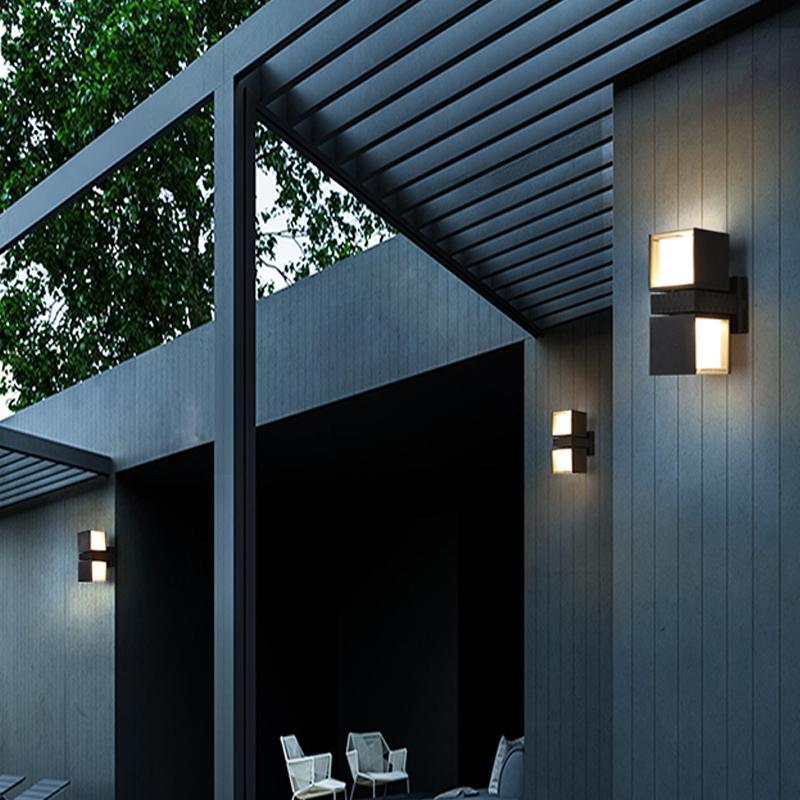 Outside up down wall lights providing ambient lighting near a wooden deck.