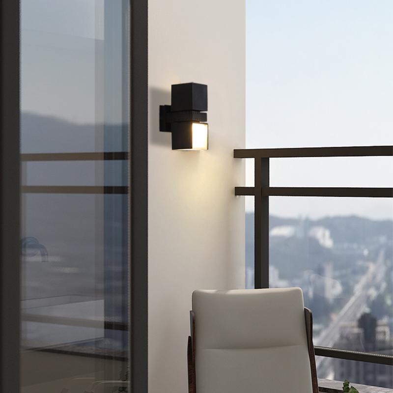 Outside up down wall lights with a black finish, illuminating a modern balcony.