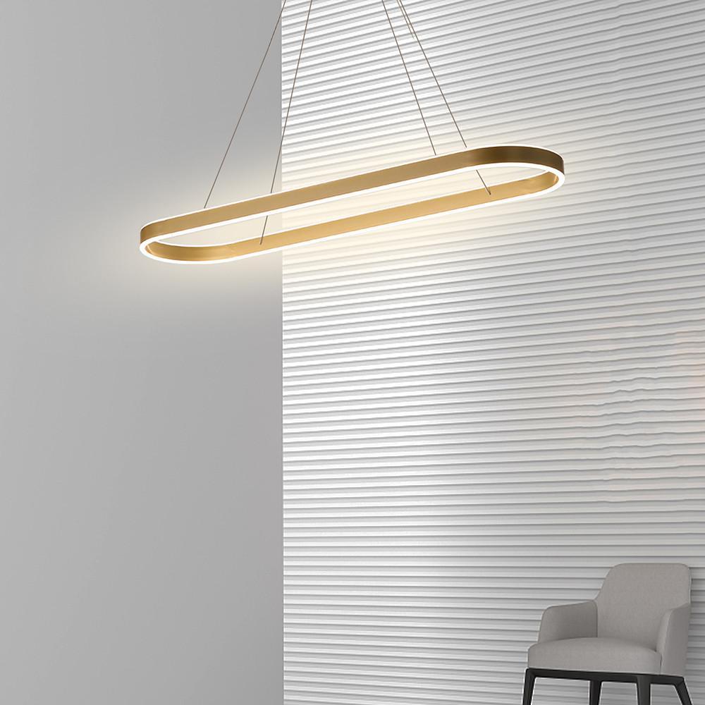Gold oval LED pendant light suspended near a textured wall for decorative lighting effect.