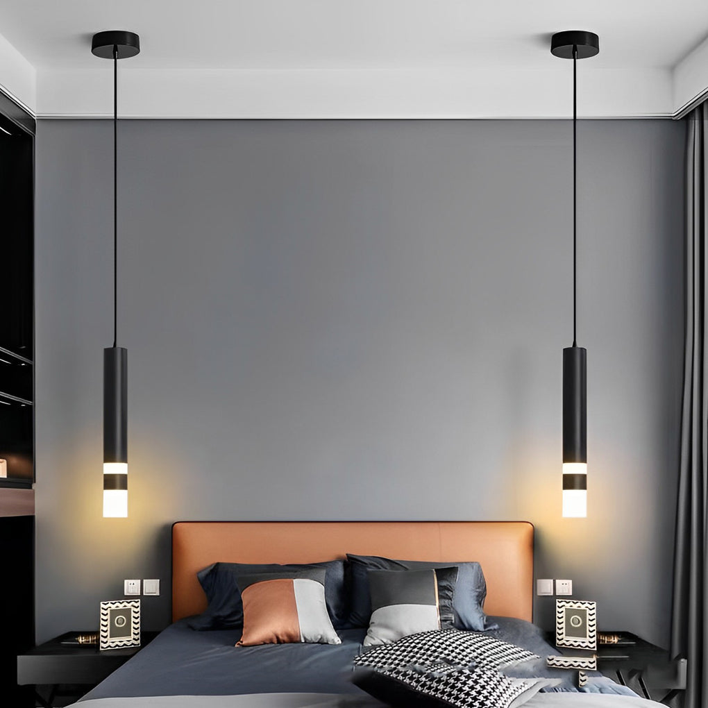 Pair of black LED cylinder pendant lights hanging over a bed with a stylish tan leather bed.