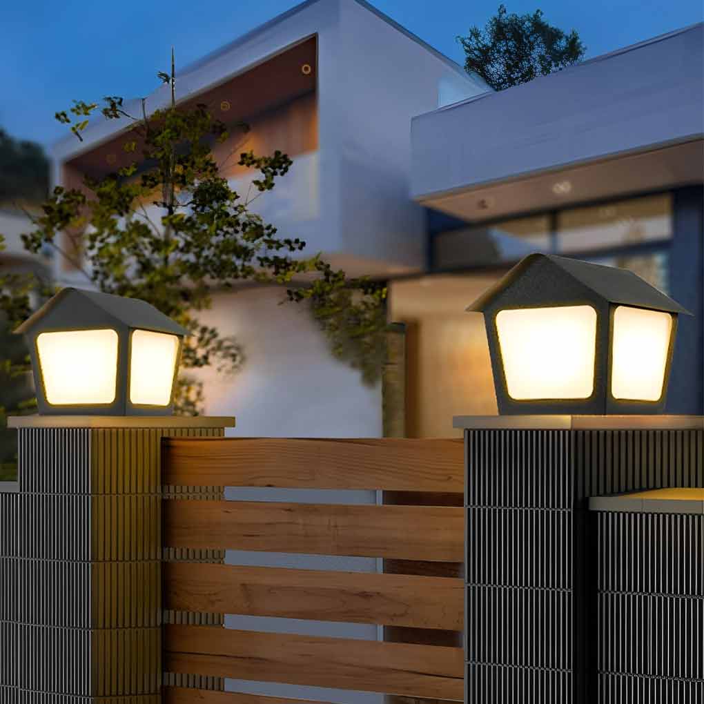 Patio pillar lights enhancing a modern outdoor seating area with warm light.