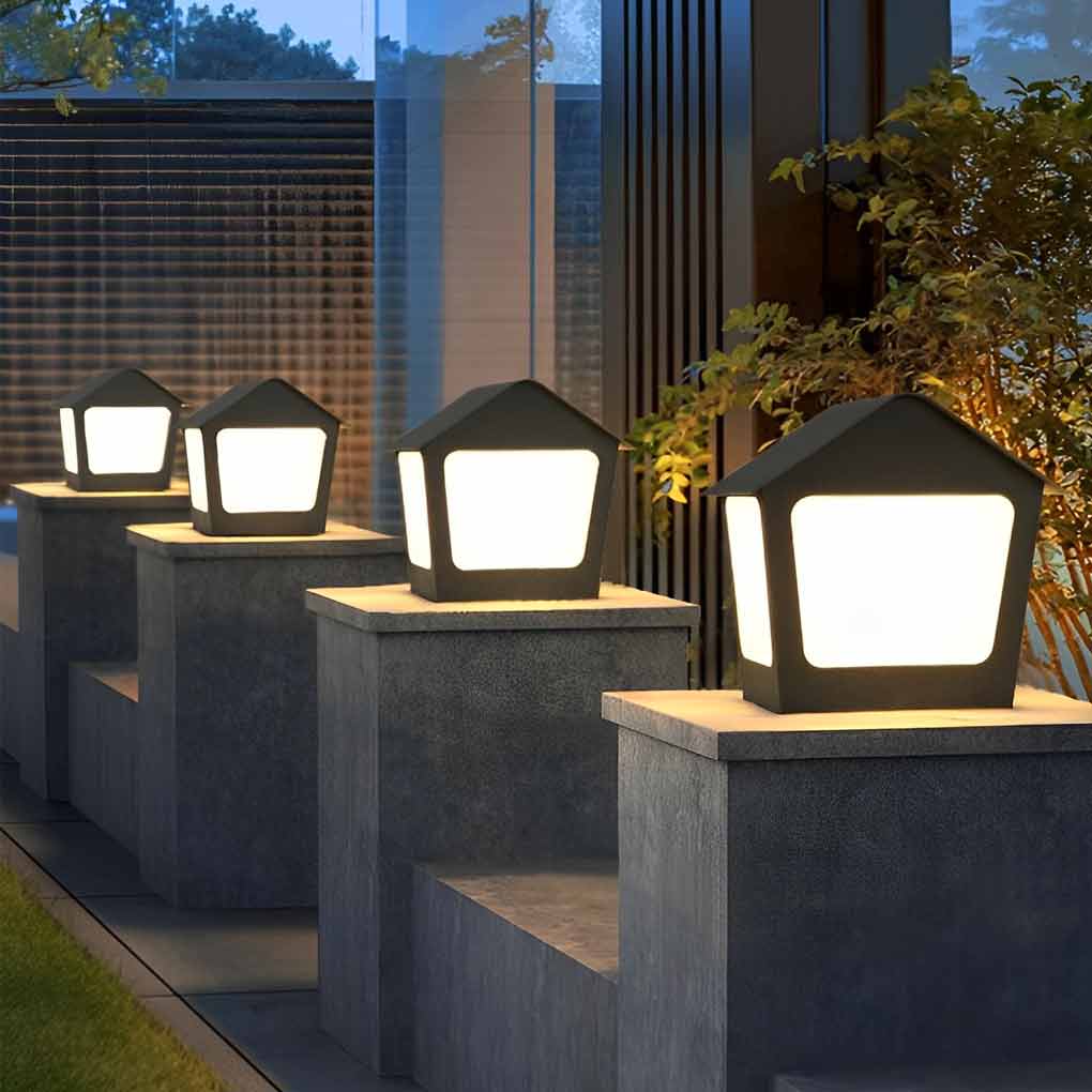Patio pillar lights providing soft illumination along a stylish driveway.