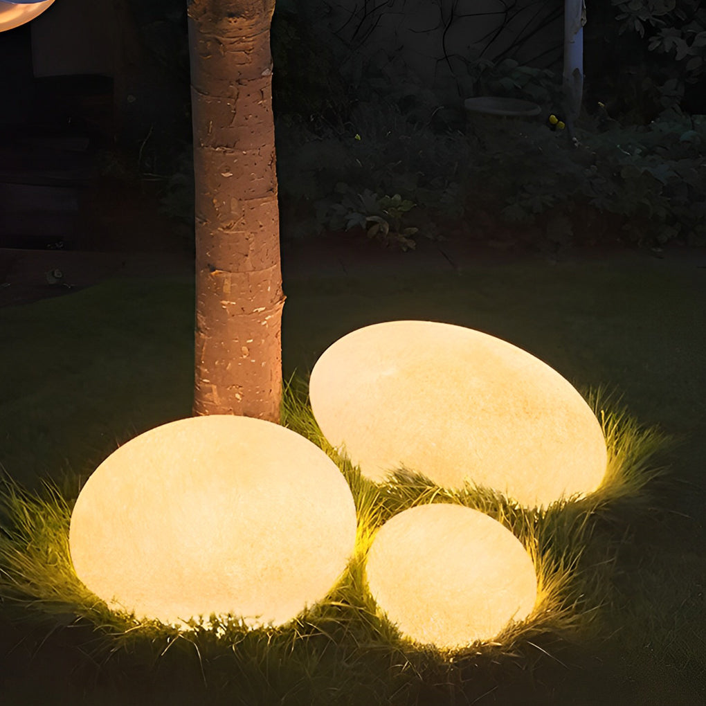 Pebble garden lights with close-up of their natural pebble design and light output.