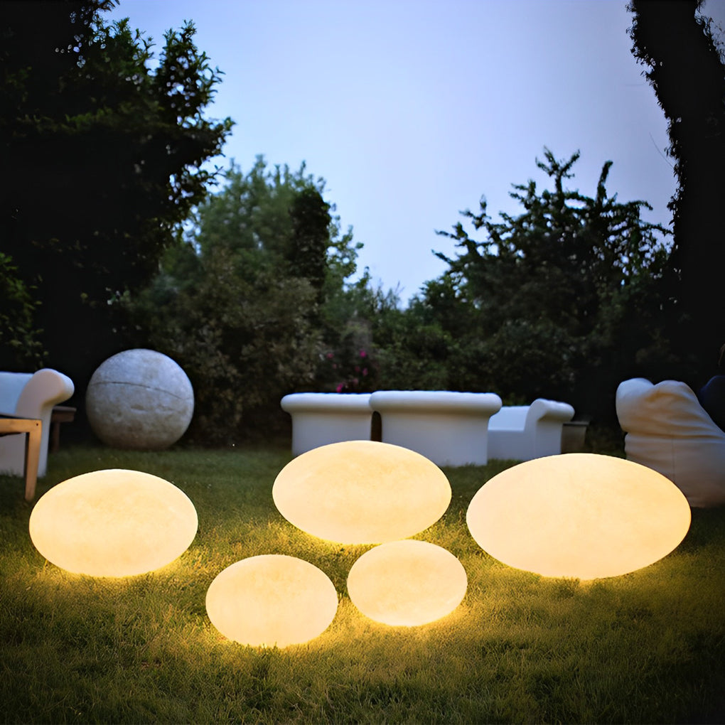 Pebble garden lights enhancing a modern outdoor deck with warm light.