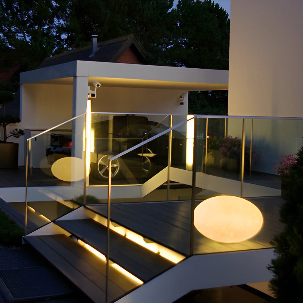Pebble garden lights enhancing a stylish outdoor terrace with warm glow.