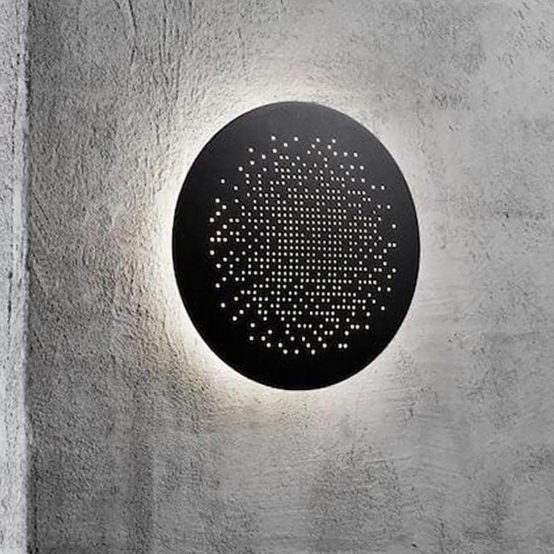 Perforated metal wall sconce close-up showing perforated shade design.