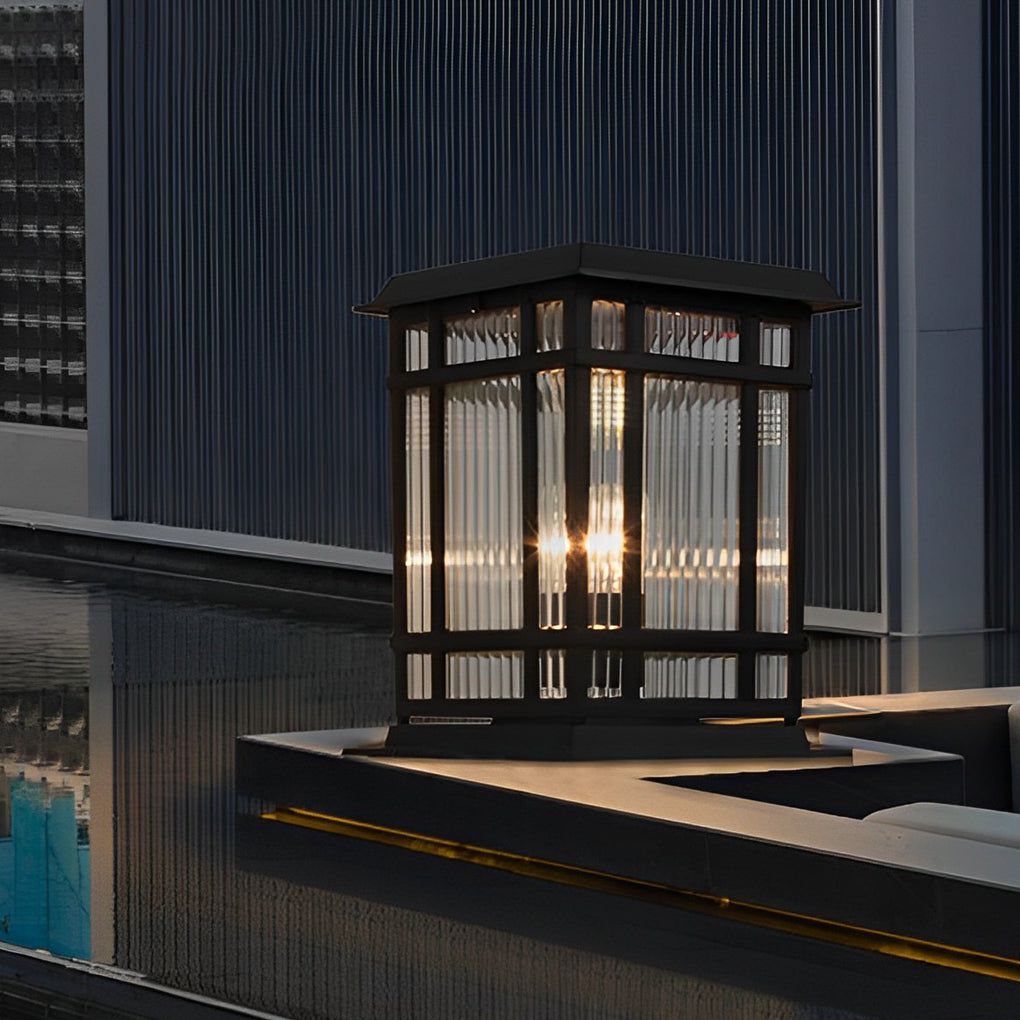 Pillar solar light showcased on a modern terrace ledge, combining vertical glass panels with soft warm illumination.