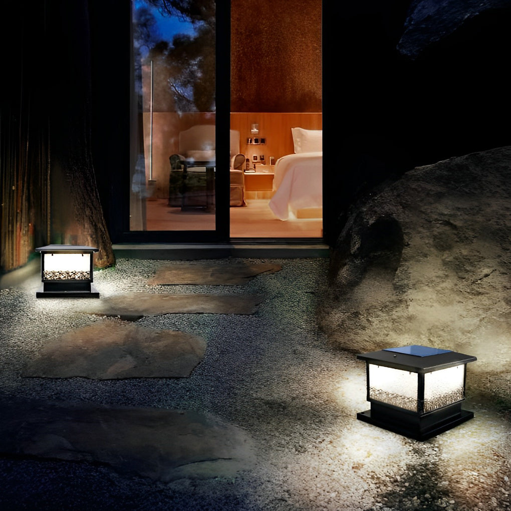 Pillar solar lights for outdoors lining an entryway path, creating a welcoming ambiance near the front door at night.