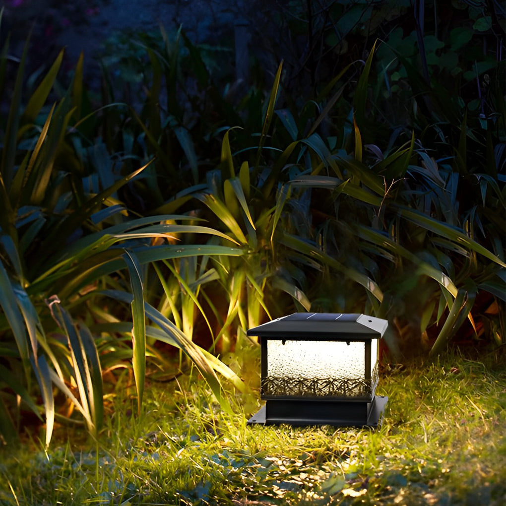 Pillar solar lights for outdoors illuminating lawn plants, blending landscape lighting with a natural garden setting.