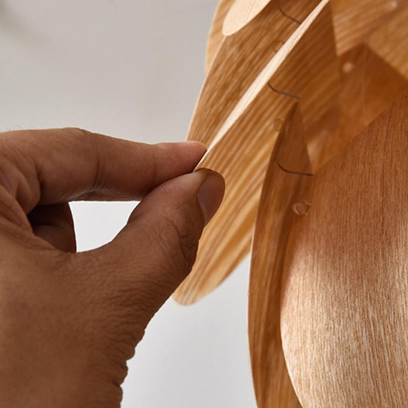 Pinecone pendant light with a layered design, providing warm light in a cozy interior.