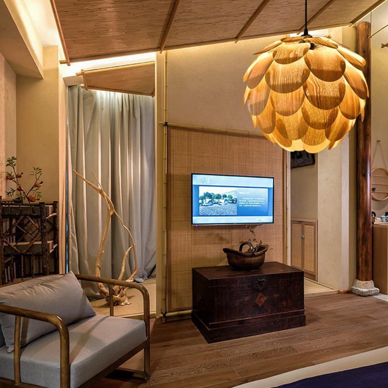 Pinecone pendant light with a layered design, mounted on a wooden ceiling.