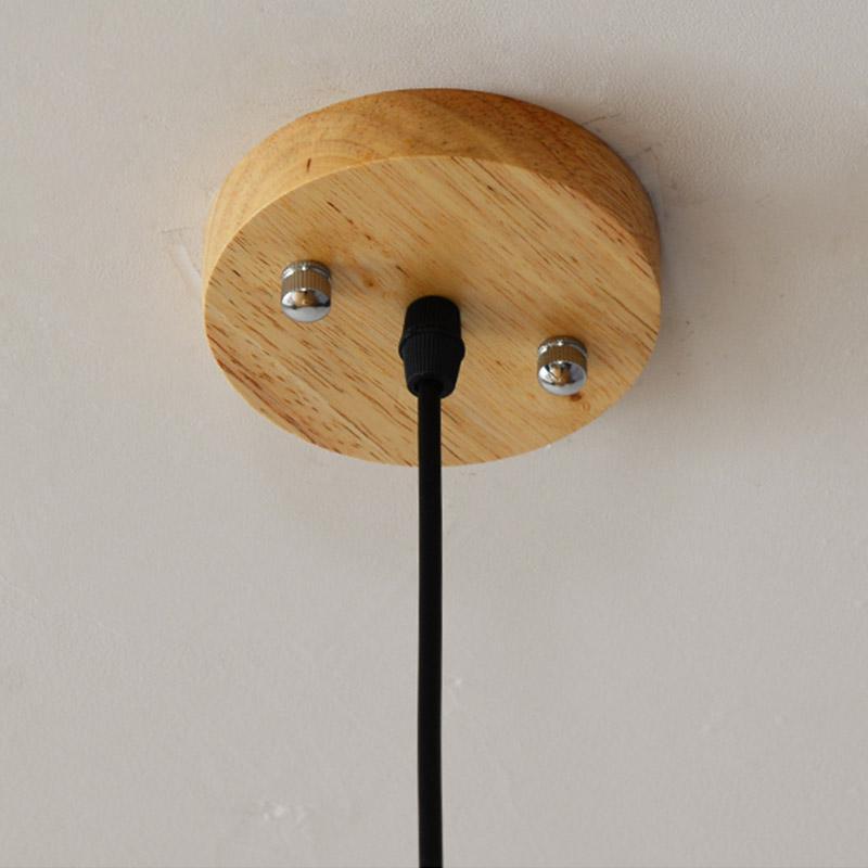 Pinecone pendant light with a natural wood design, providing soft illumination.