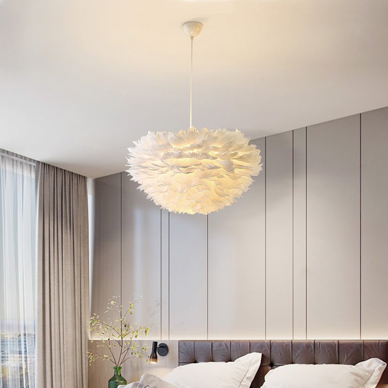 Pink feather pendant light creates a fashionable, cozy atmosphere. Elevate your home décor with this elegant ceiling fixture.