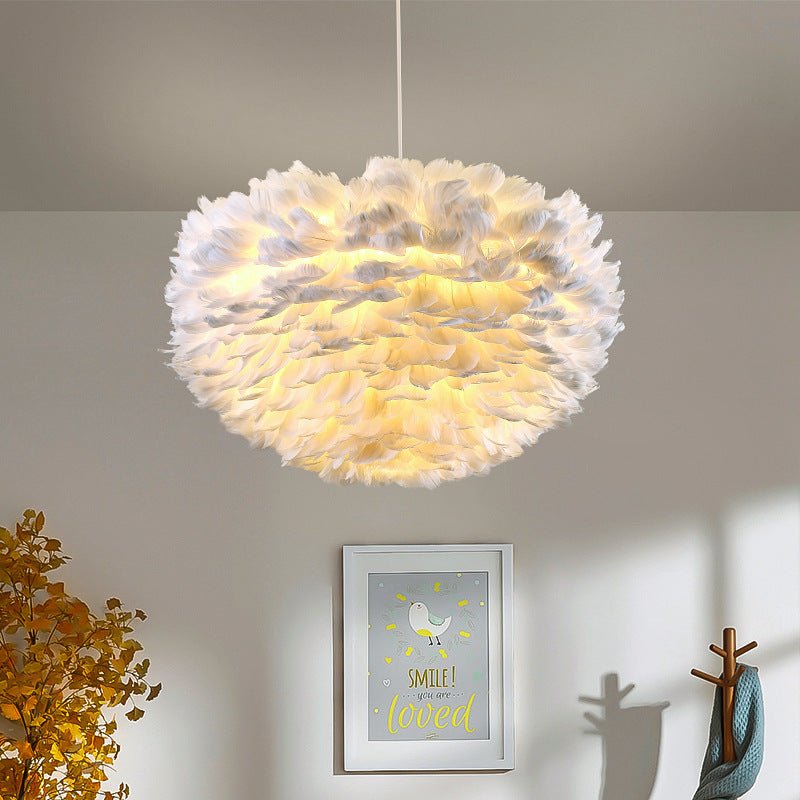 Pink feather pendant light brings a soft, stylish glow. Ideal for modern interiors seeking a chic and decorative fixture.