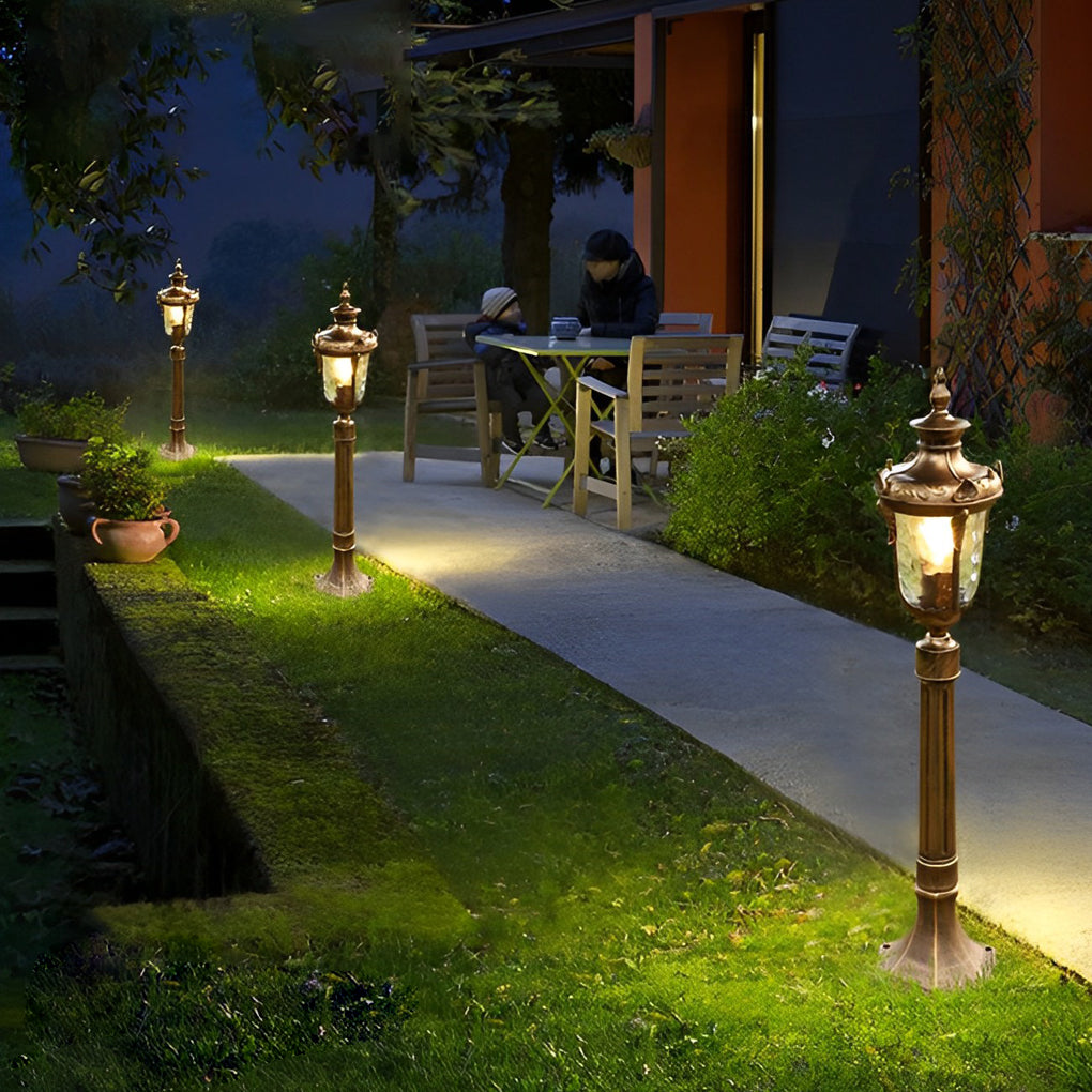 Poles for yard lights enhancing a garden pathway with warm, inviting glow.