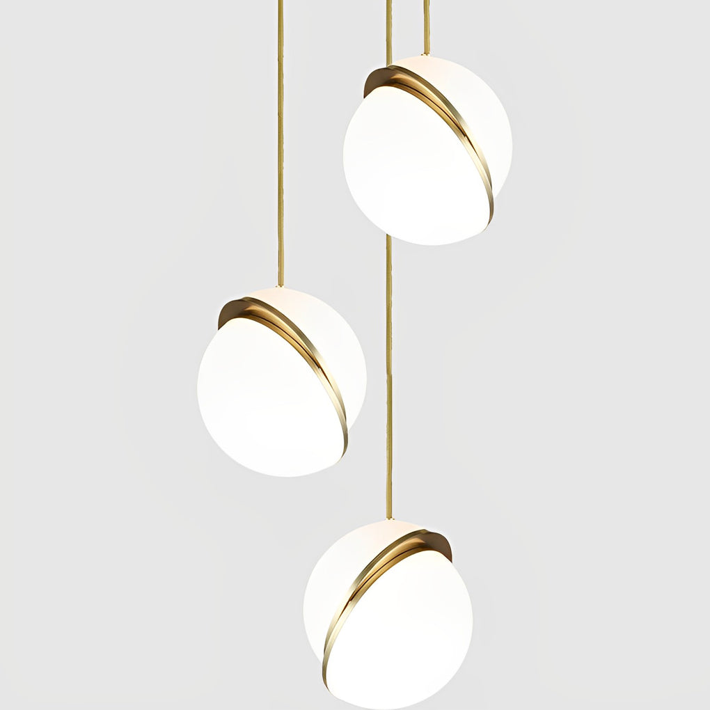 Product detail of a three-light White Spherical Pendant Light cluster with brass details.