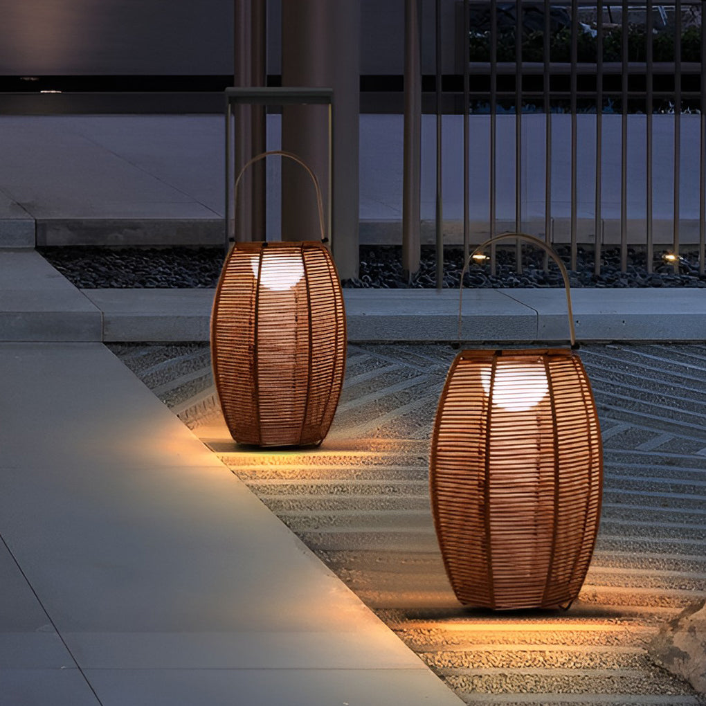 Rattan floor lantern providing soft illumination along a stylish garden pathway.