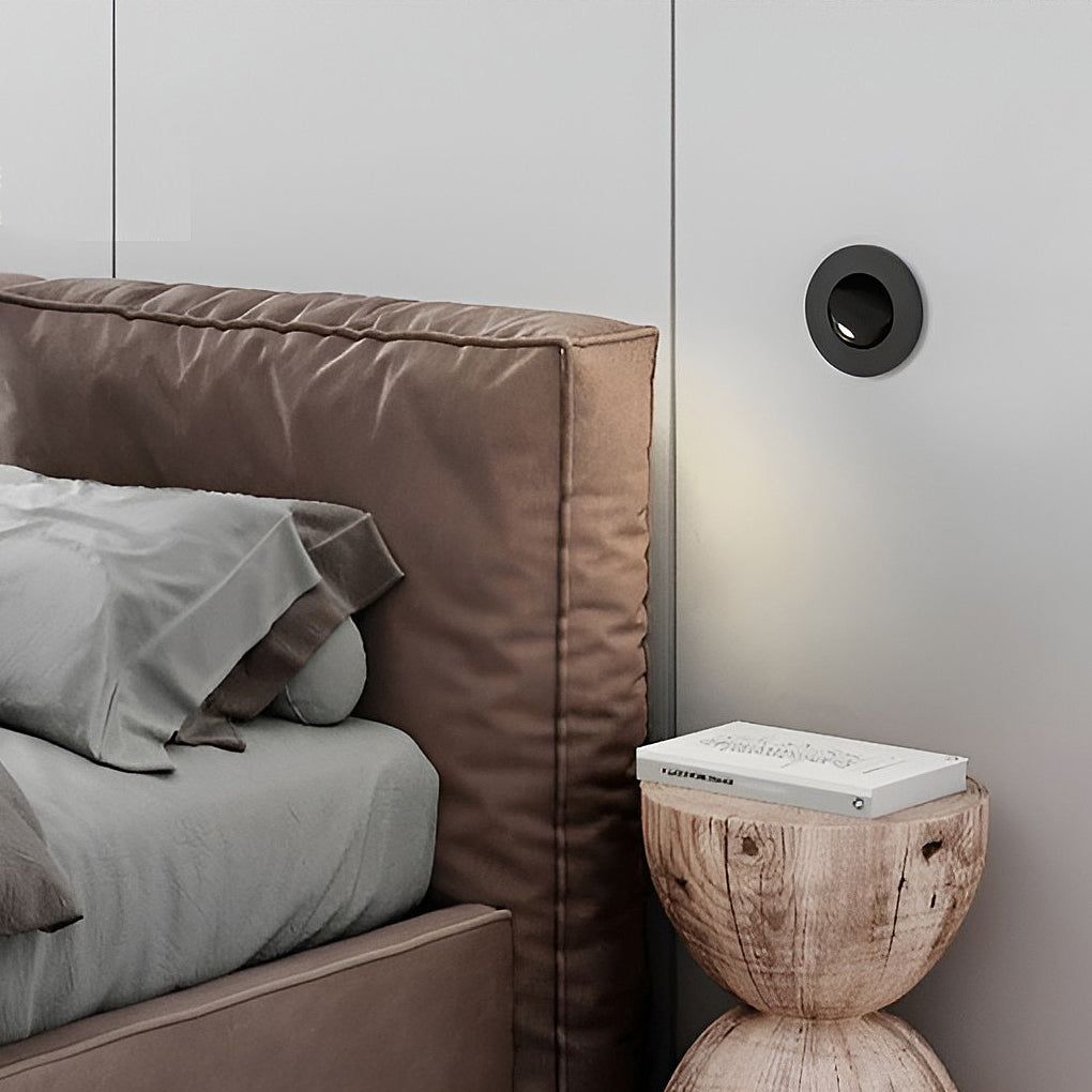 Contemporary bedroom corner featuring black recessed led reading lamp wall installation.