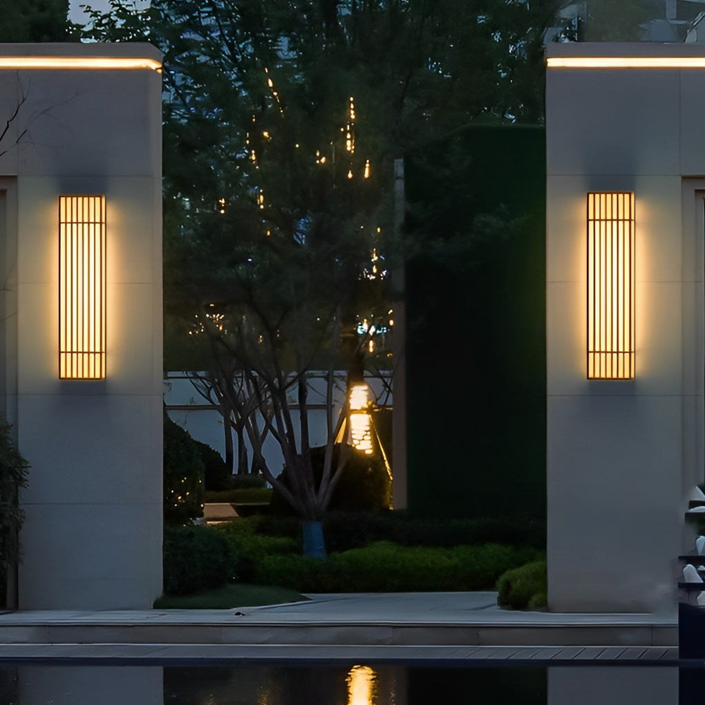 Rectangle LED outdoor wall light illuminating a garden wall at night
