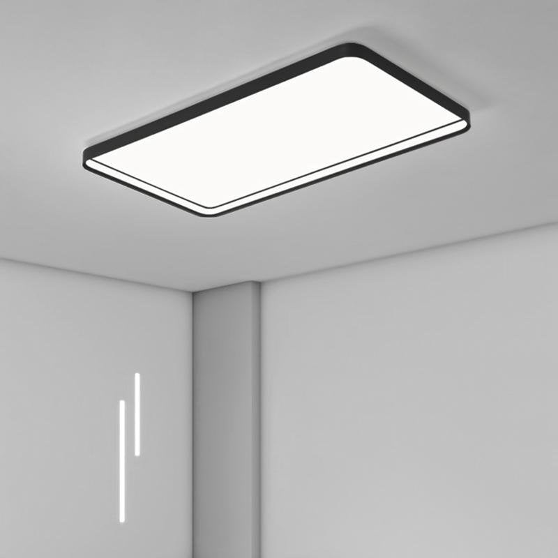 Rectangular flush mount ceiling light illuminating a stylish living room with white sofas.