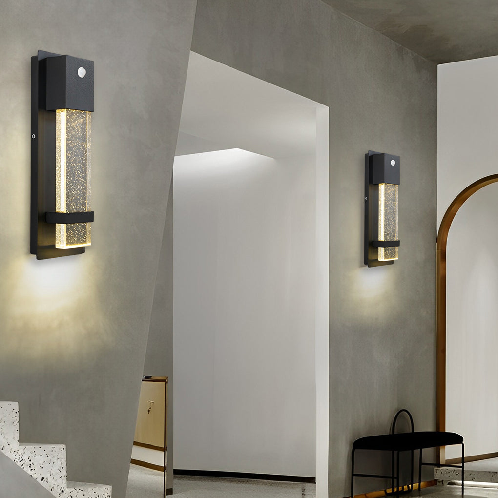 Rectangular outdoor wall lights installed in indoor-outdoor transition space with concrete walls.