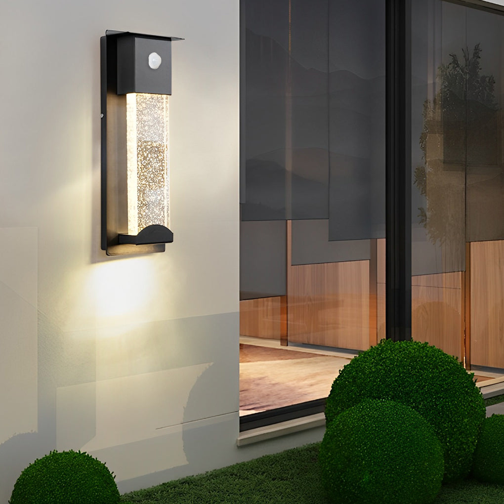 Rectangular outdoor wall lights providing soft downward lighting beside modern home entrance.