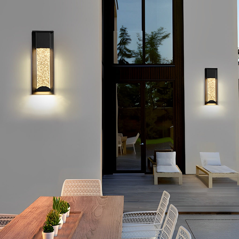 Minimalist rectangular outdoor wall lights illuminating modern patio wall and outdoor seating area.