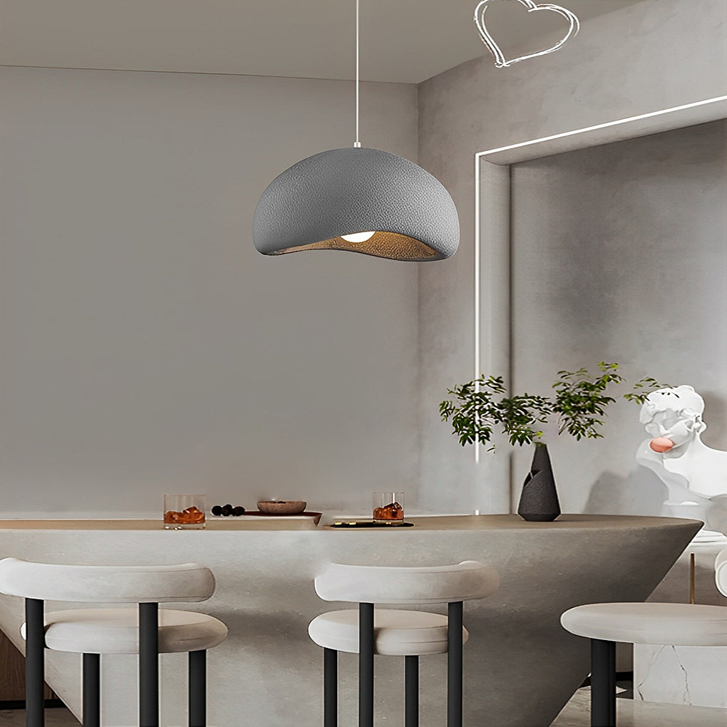 Resin pendant light with a minimalist design, hanging in a modern dining room with natural light.