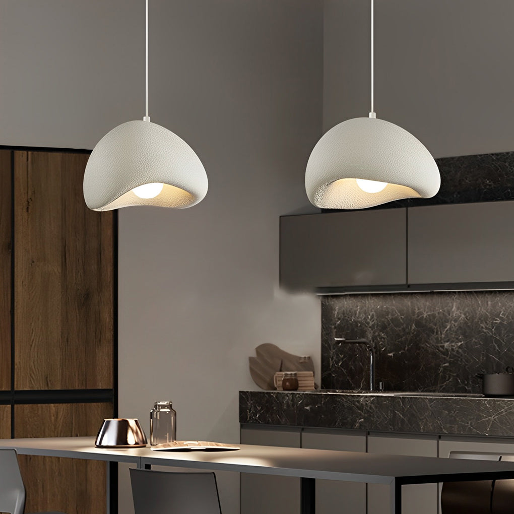 Resin pendant light with a unique textured design, illuminating a modern kitchen island.