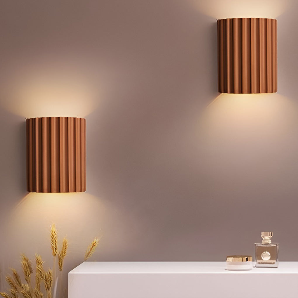 Ribbed wall sconces enhancing a contemporary sofa area with warm light.