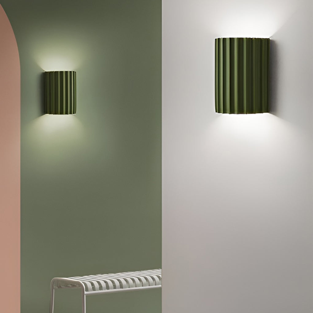 Ribbed wall sconces providing elegant illumination for a modern bedroom.