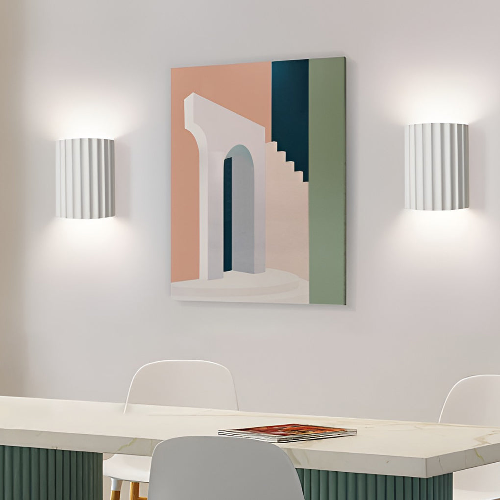 Ribbed wall sconces providing soft illumination in a stylish dining area.