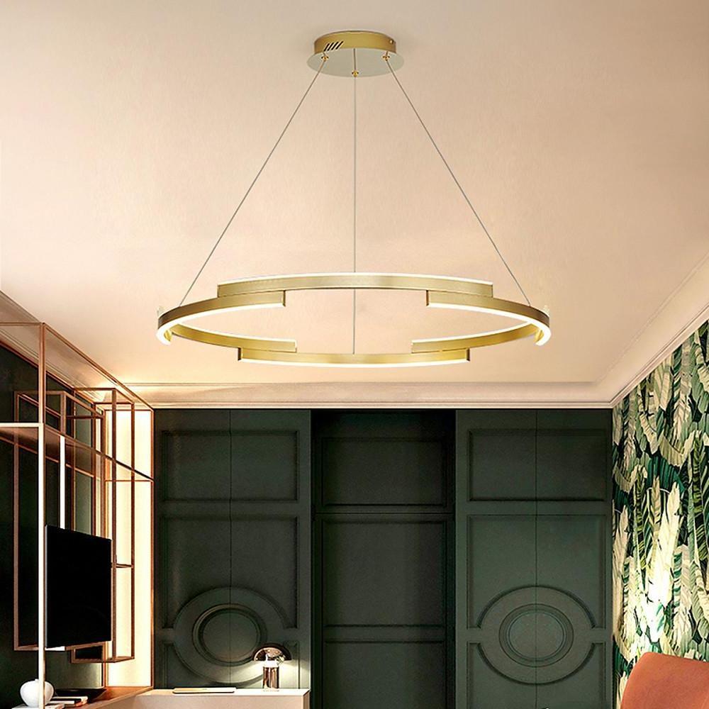 Ring chandelier brass casting a gentle glow in a chic dining room.