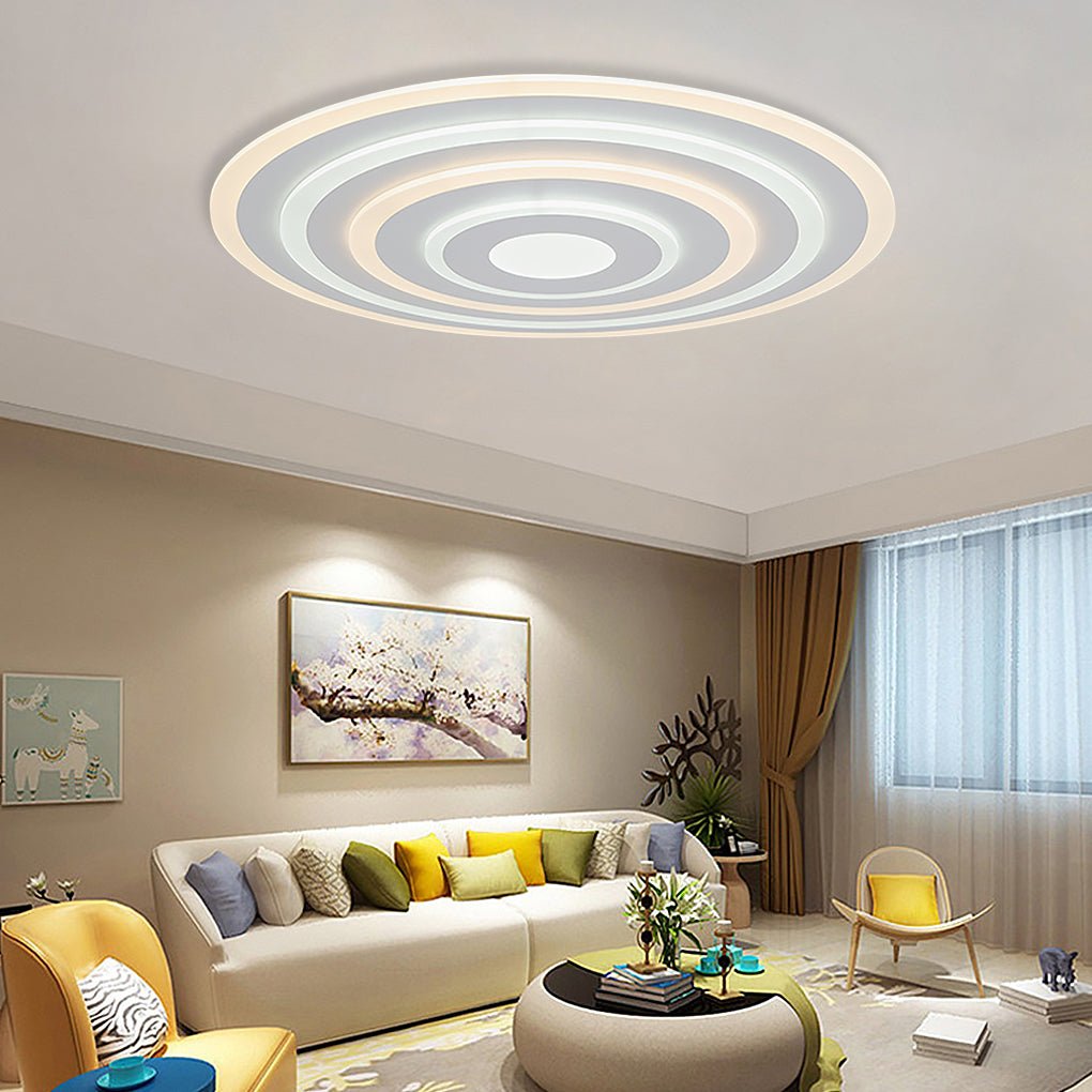 Round flush mount ceiling light with a layered design, providing ambient lighting in a stylish living room.