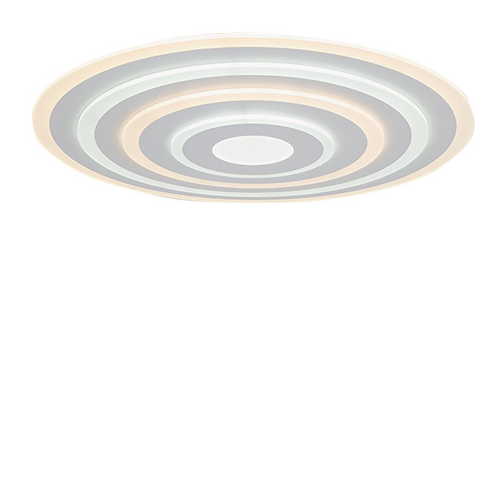 Round flush mount ceiling light with a sleek design, illuminating a stylish room.