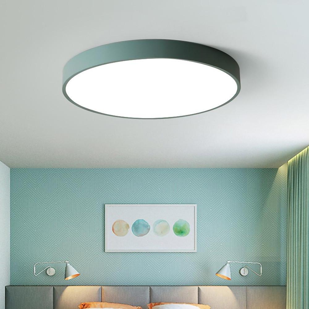 Green round led ceiling lights with minimalist design brightening a modern bedroom space.
