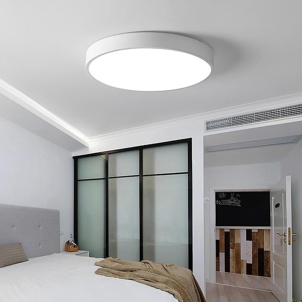 White round led ceiling lights installed in a contemporary bedroom with clean ceiling design.