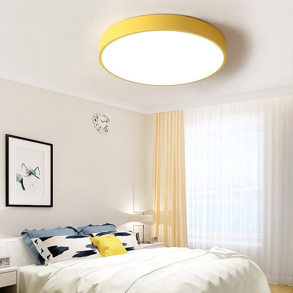 Yellow round led ceiling lights adding warm illumination to a cozy modern bedroom interior.