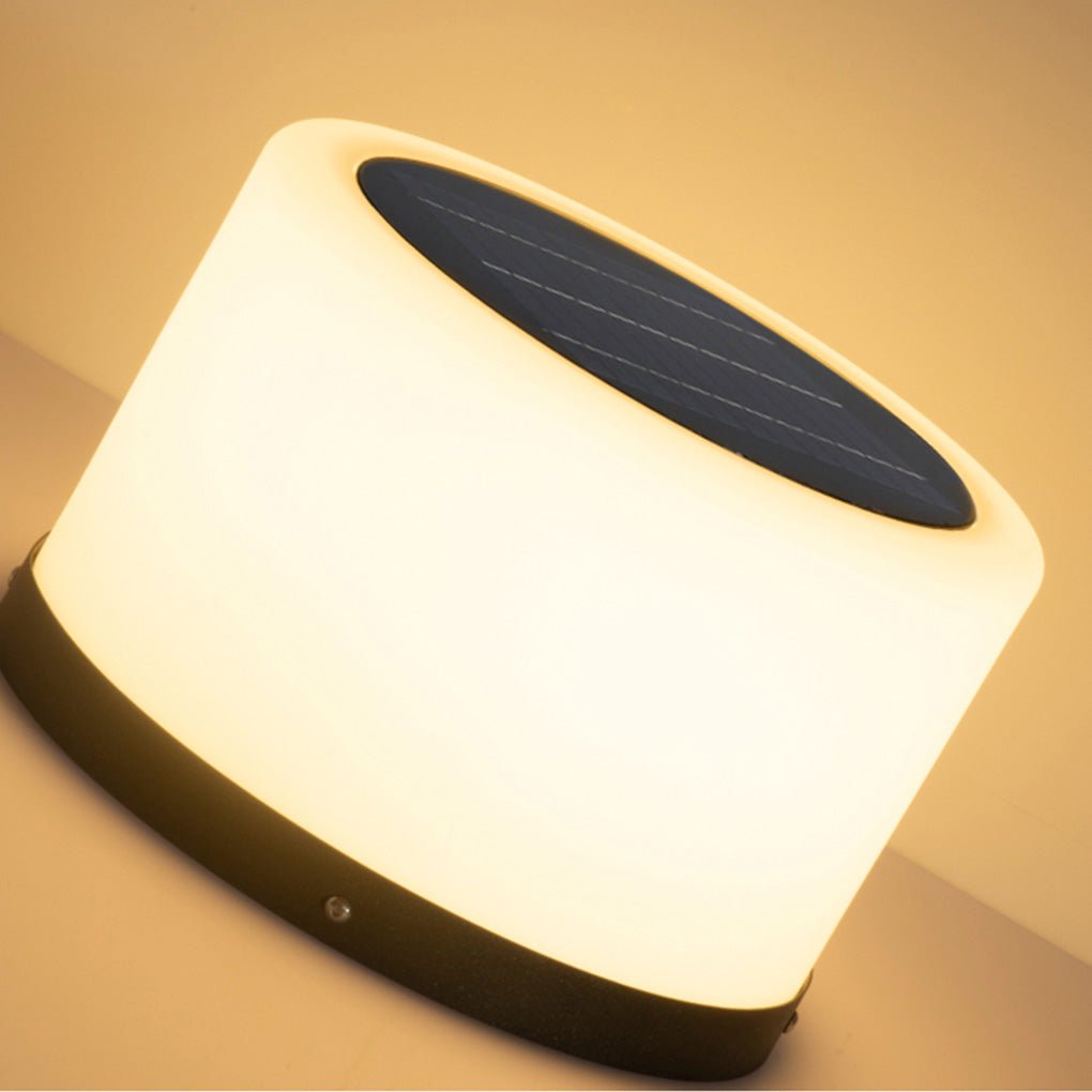 Round pillar lights displayed on concrete pillars in a garden.