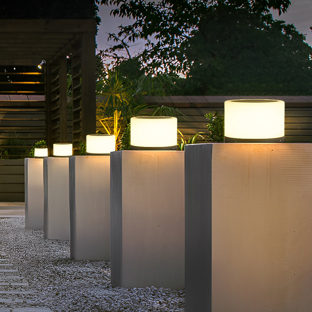 Round pillar lights enhancing a contemporary outdoor space with a minimalist design.