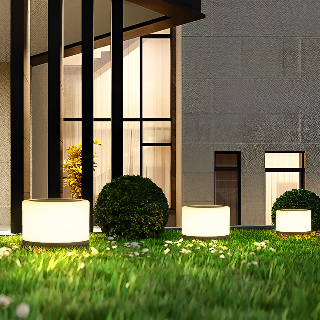 Round pillar lights providing subtle illumination on a patio.