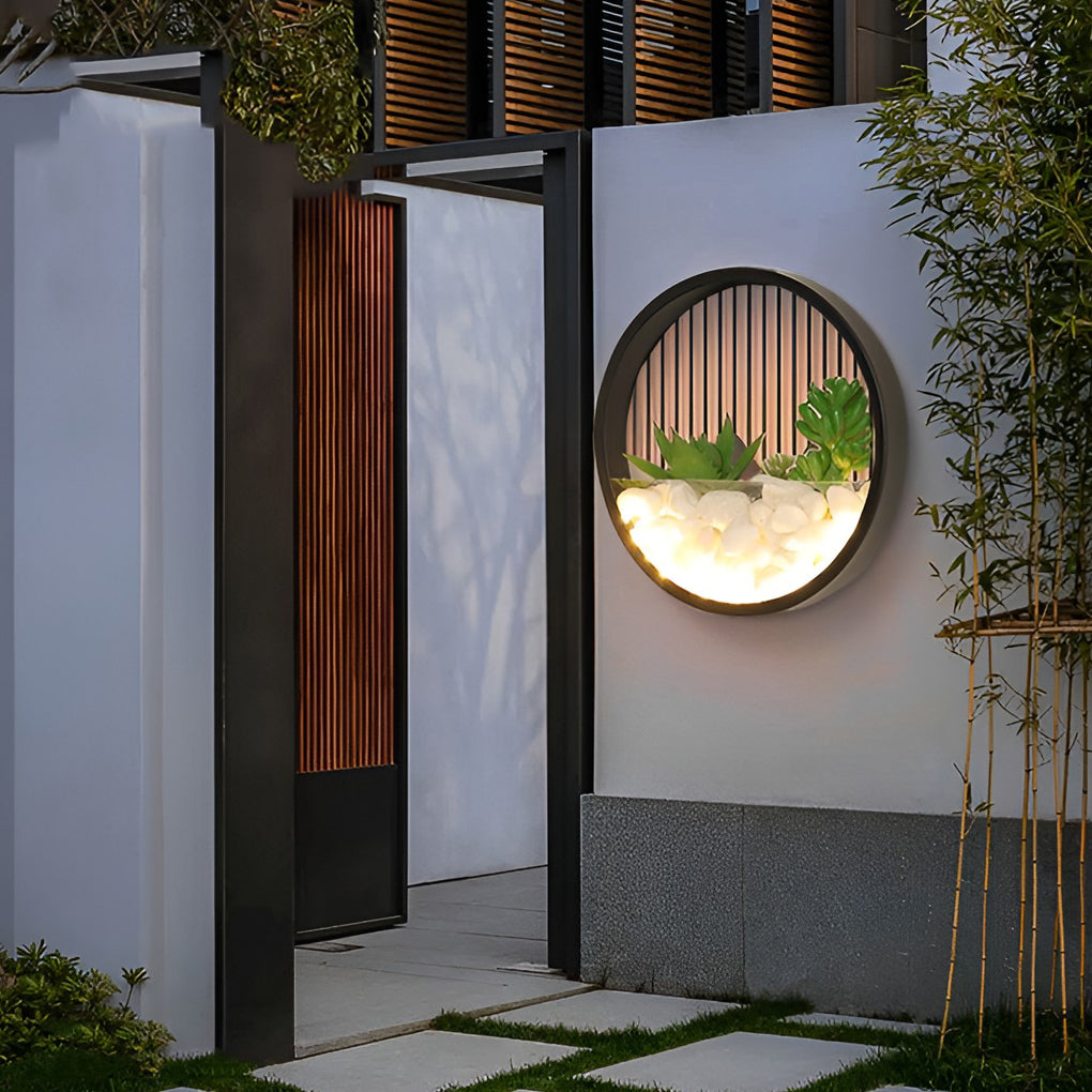 Round plant wall lamp enhancing a modern outdoor seating area with warm glow.