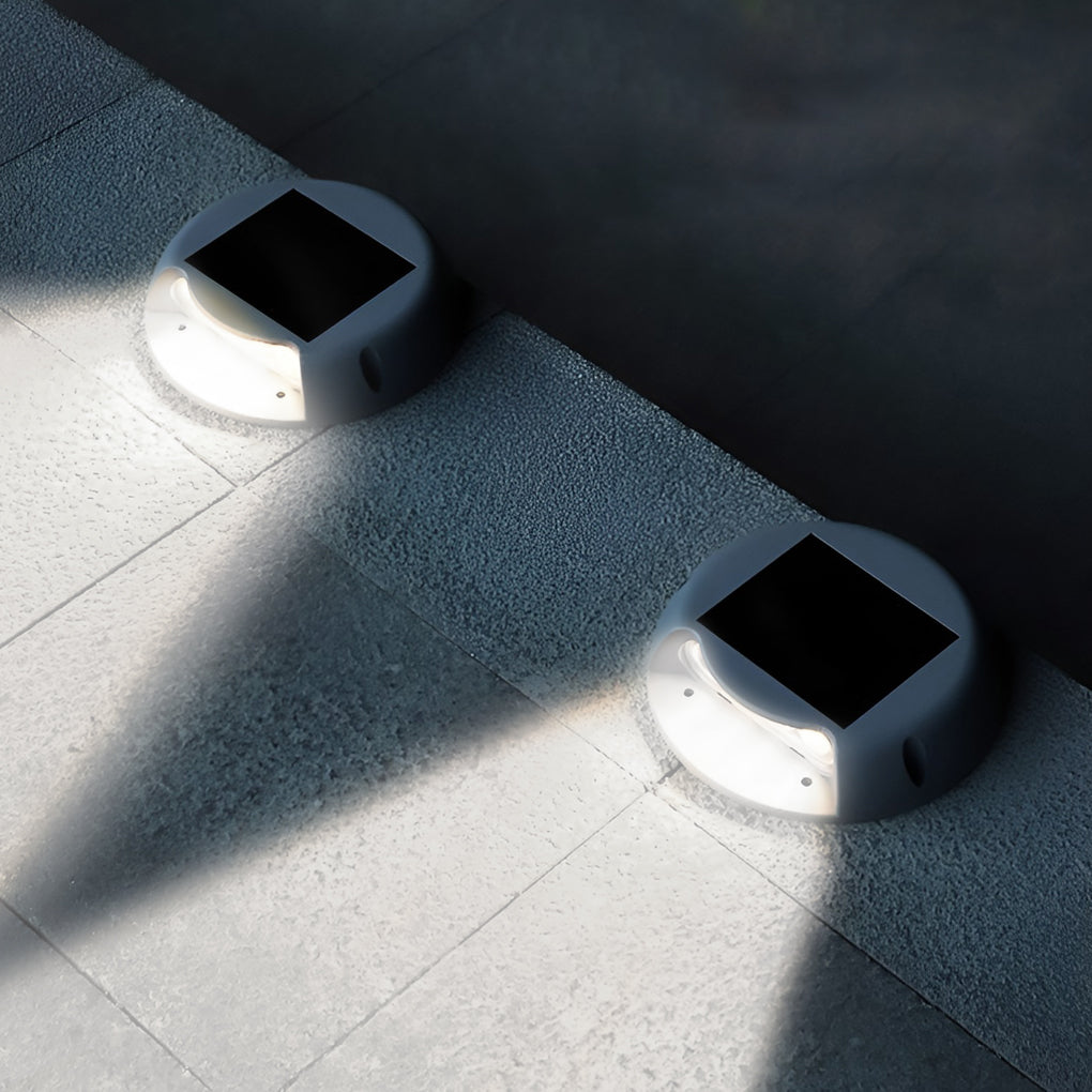 LED deck pathway lighting with round solar-powered design, mounted on tiled edge for subtle and modern illumination