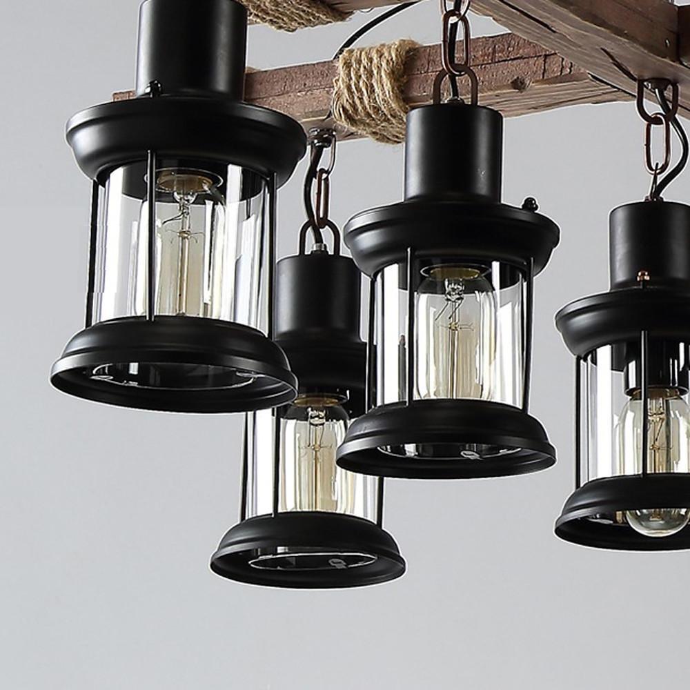 Black metal and glass lantern lights used on rustic wood chandelier.